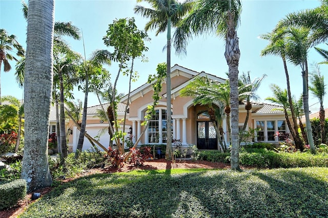 mediterranean / spanish house with a garage and stucco siding