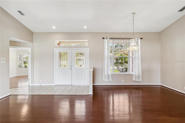 interior space featuring french doors, wood-type flooring, and a chandelier