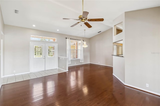 unfurnished living room featuring french doors, ceiling fan, and wood-type flooring