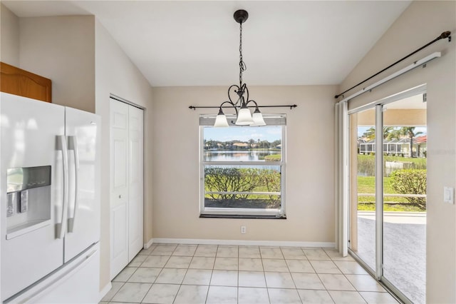 unfurnished dining area with vaulted ceiling and a water view