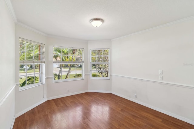 spare room with crown molding and hardwood / wood-style floors