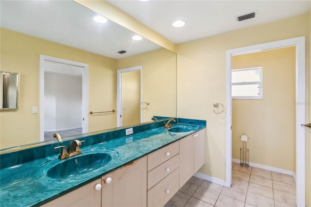 bathroom with tile patterned floors and vanity