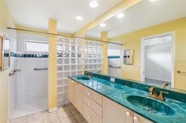 bathroom featuring vanity, tiled shower, and tile patterned floors