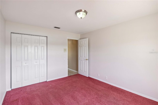 unfurnished bedroom with carpet floors and a closet