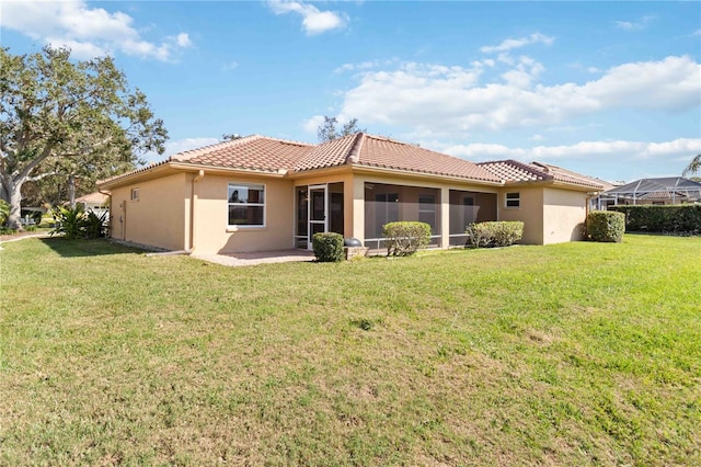 rear view of property featuring a lawn