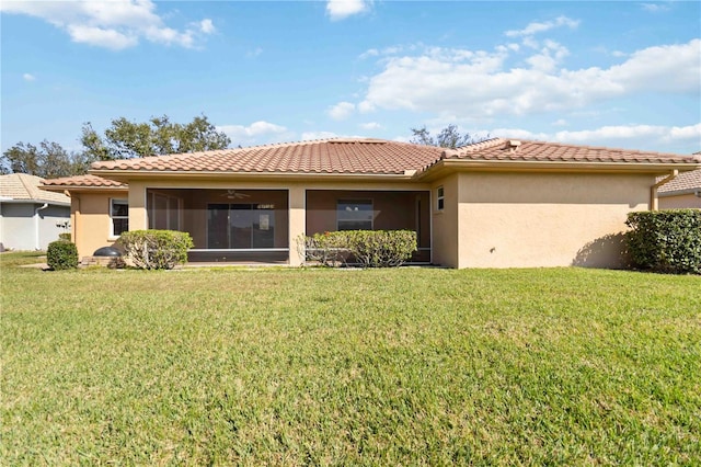 view of front of home with ceiling fan, a front yard, and a sunroom