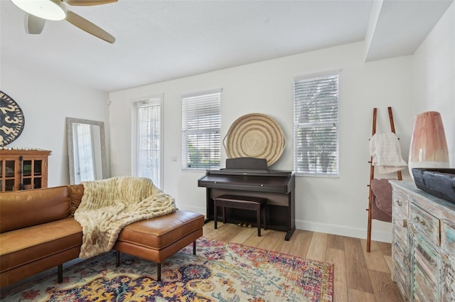 living room featuring ceiling fan and light wood-type flooring