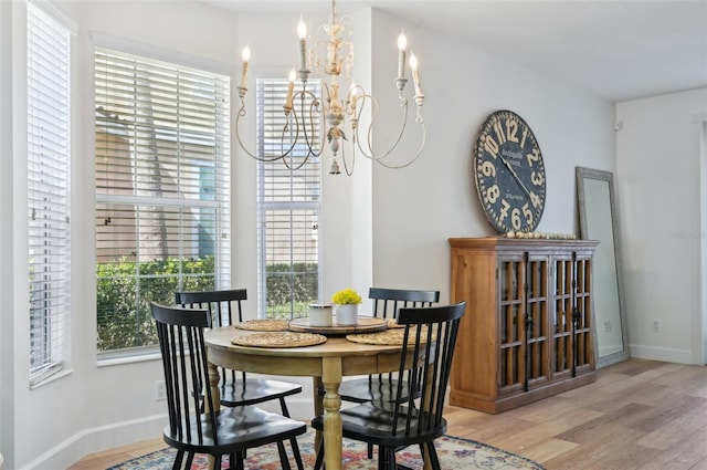 dining space featuring a notable chandelier and light hardwood / wood-style flooring