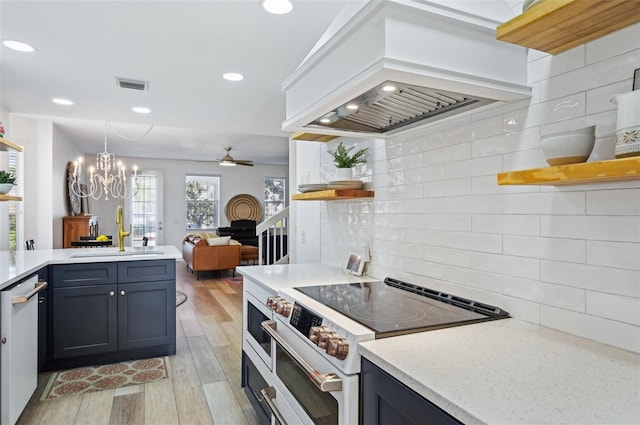 kitchen with pendant lighting, sink, white appliances, light hardwood / wood-style floors, and custom exhaust hood