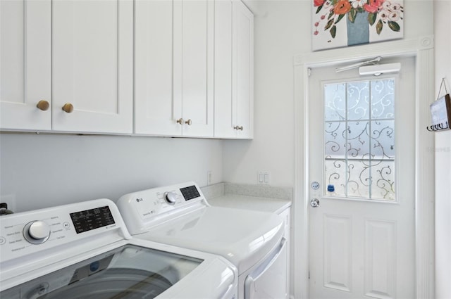 laundry room with cabinets and washer and dryer