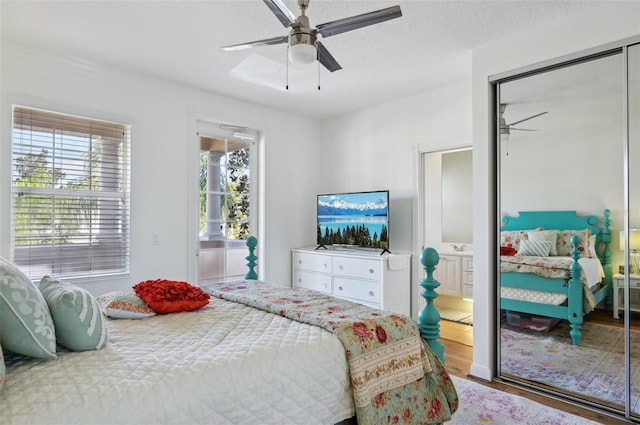 bedroom featuring ceiling fan, hardwood / wood-style floors, ensuite bathroom, a textured ceiling, and a closet