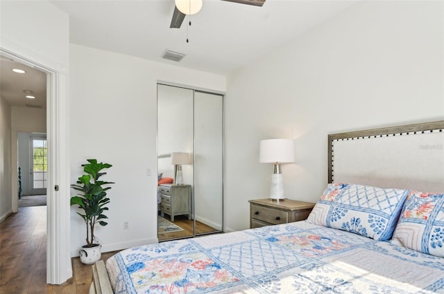 bedroom with hardwood / wood-style flooring, ceiling fan, and a closet