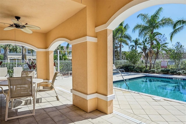 view of swimming pool with ceiling fan and a patio area