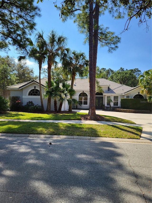 ranch-style home featuring a front yard