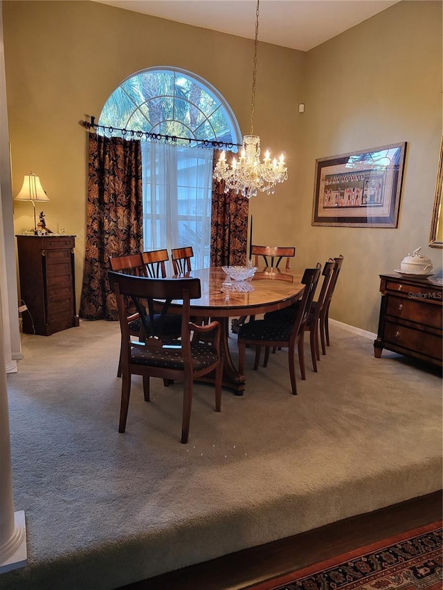 carpeted dining space featuring a chandelier