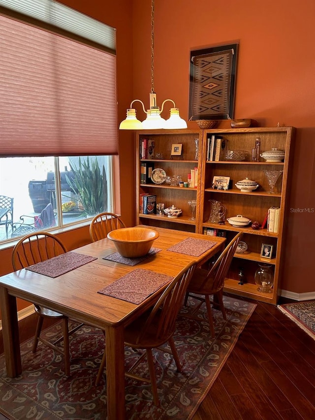 dining space with dark wood-type flooring