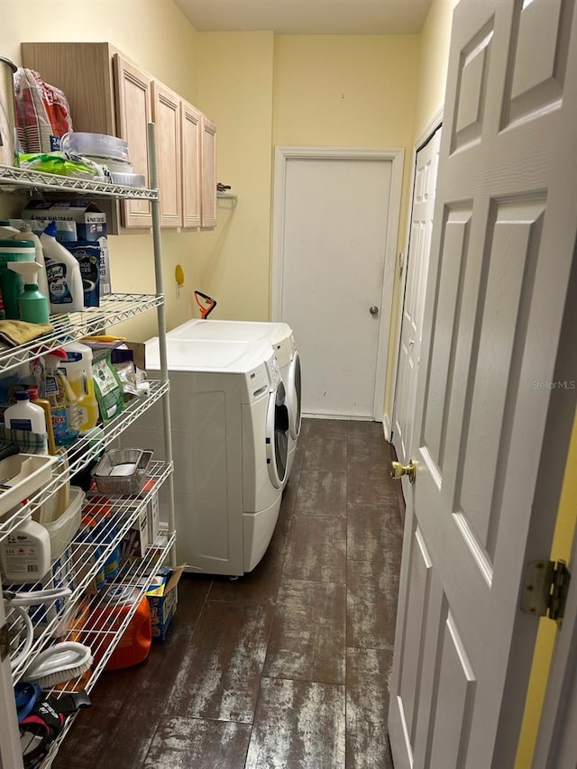 clothes washing area with washing machine and dryer and cabinets