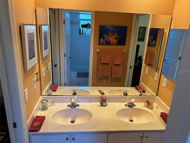 bathroom with vanity and tiled shower