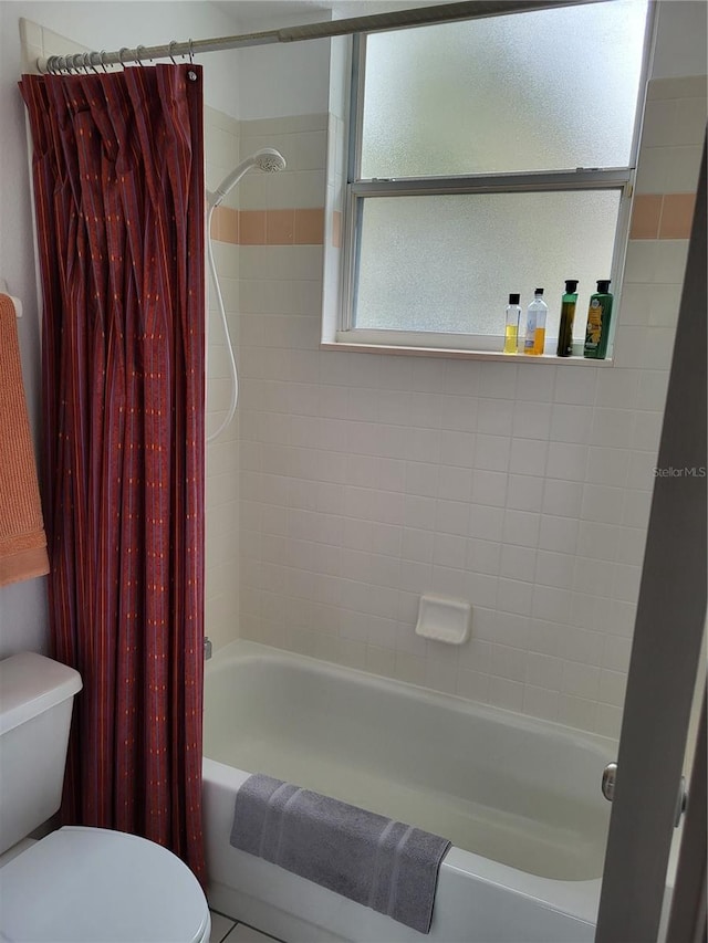 bathroom with toilet and shower / bathtub combination with curtain