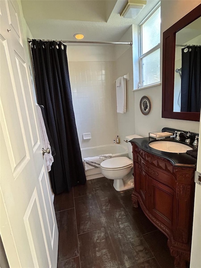 full bathroom featuring vanity, shower / tub combo with curtain, and toilet