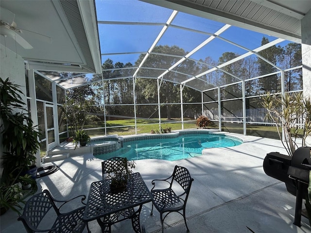 view of swimming pool with an in ground hot tub, glass enclosure, and a patio area