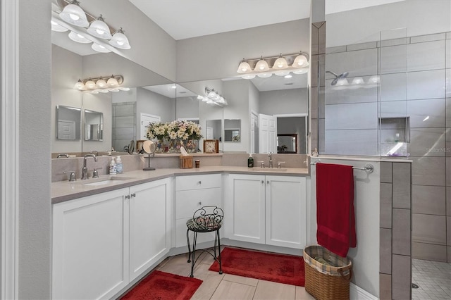 full bath with tile patterned flooring, double vanity, walk in shower, and a sink