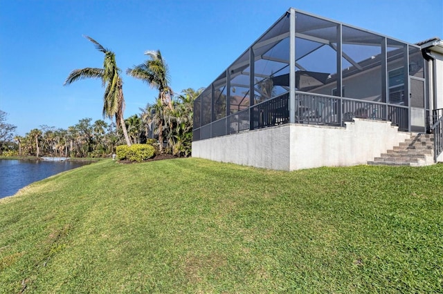 view of yard featuring glass enclosure and a water view