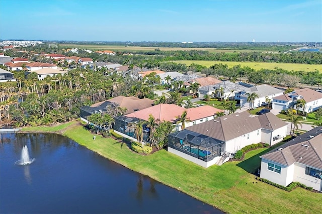 drone / aerial view featuring a residential view and a water view