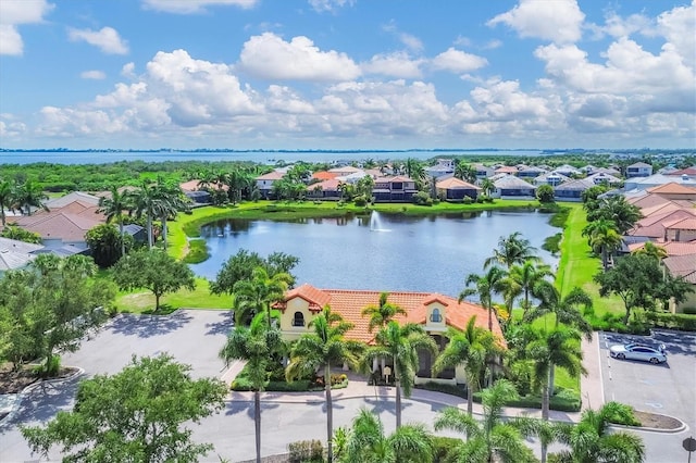 drone / aerial view with a residential view and a water view