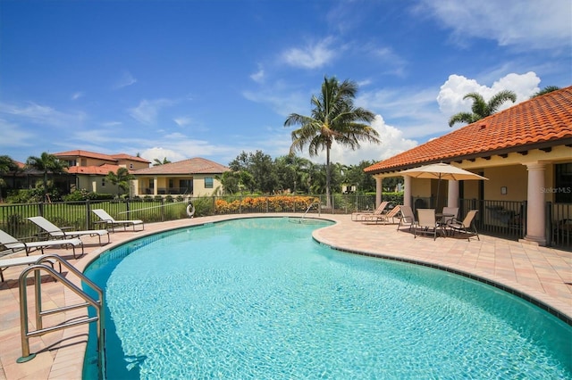 pool featuring a patio and fence