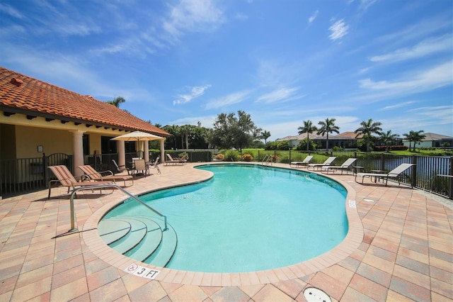 pool featuring a patio area and fence