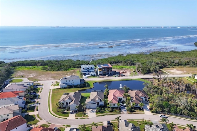 drone / aerial view with a water view and a residential view