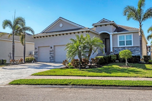 view of front facade featuring stucco siding, a front lawn, decorative driveway, stone siding, and an attached garage