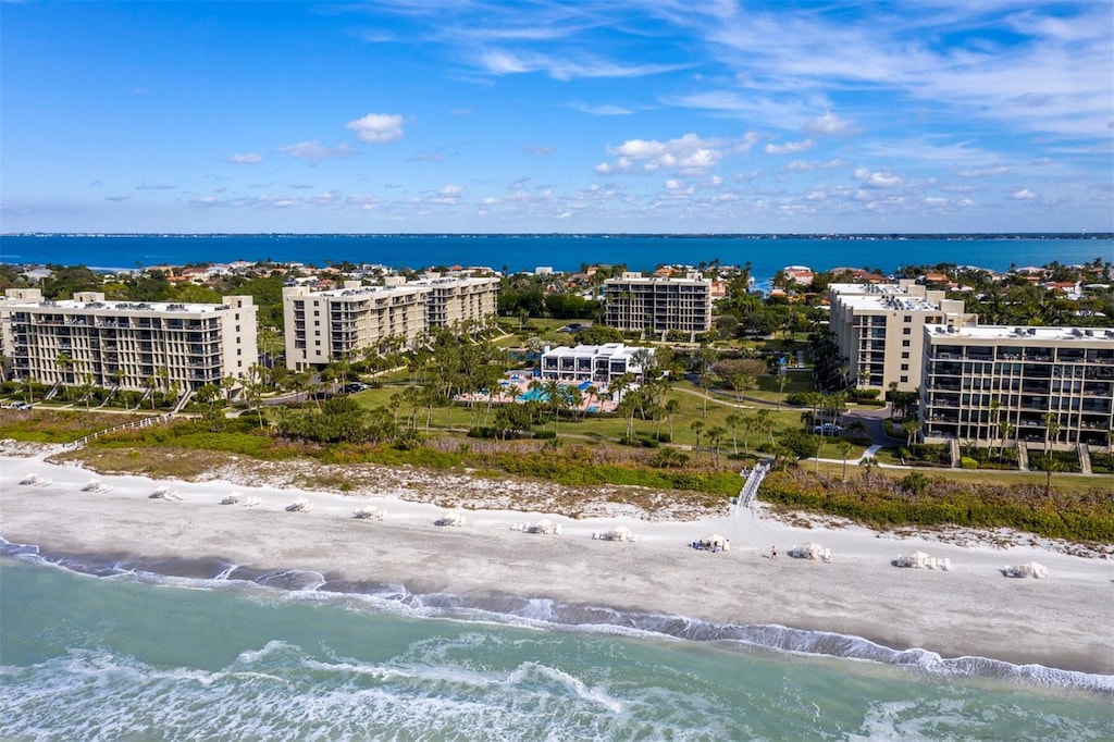 bird's eye view with a water view and a beach view