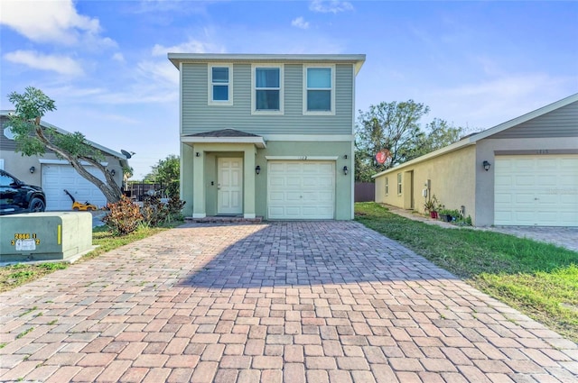 view of front facade with decorative driveway and stucco siding