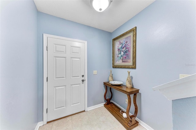 entryway featuring light tile patterned floors and baseboards