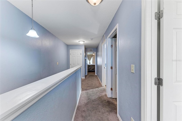 corridor with dark carpet and baseboards