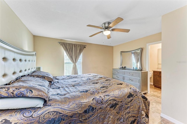 bedroom featuring light tile patterned floors, a textured ceiling, baseboards, and a ceiling fan