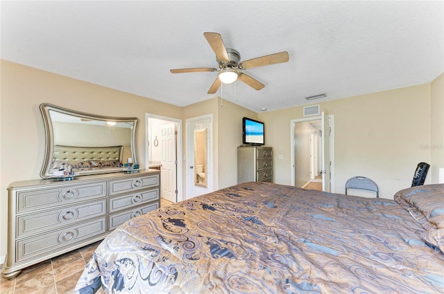 bedroom with ceiling fan, connected bathroom, and visible vents