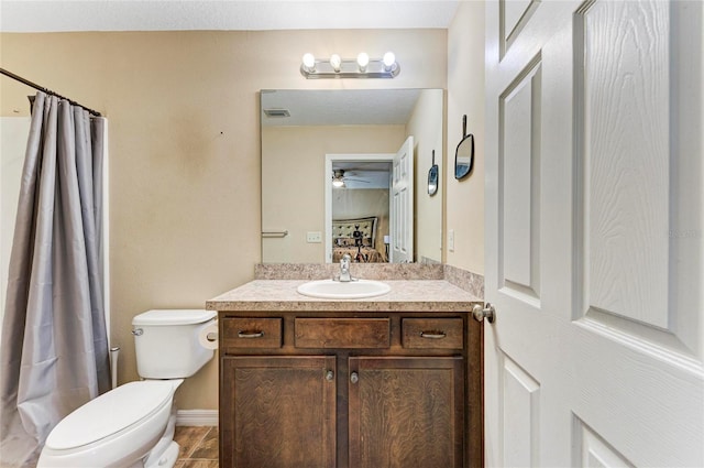 full bath with toilet, ensuite bath, a ceiling fan, and vanity