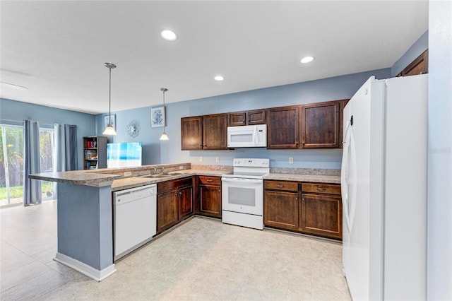 kitchen with pendant lighting, a sink, dark brown cabinets, white appliances, and a peninsula