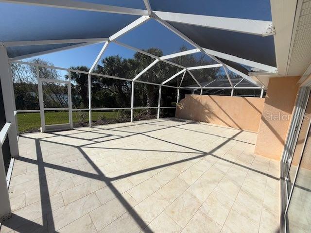 view of patio featuring a lanai