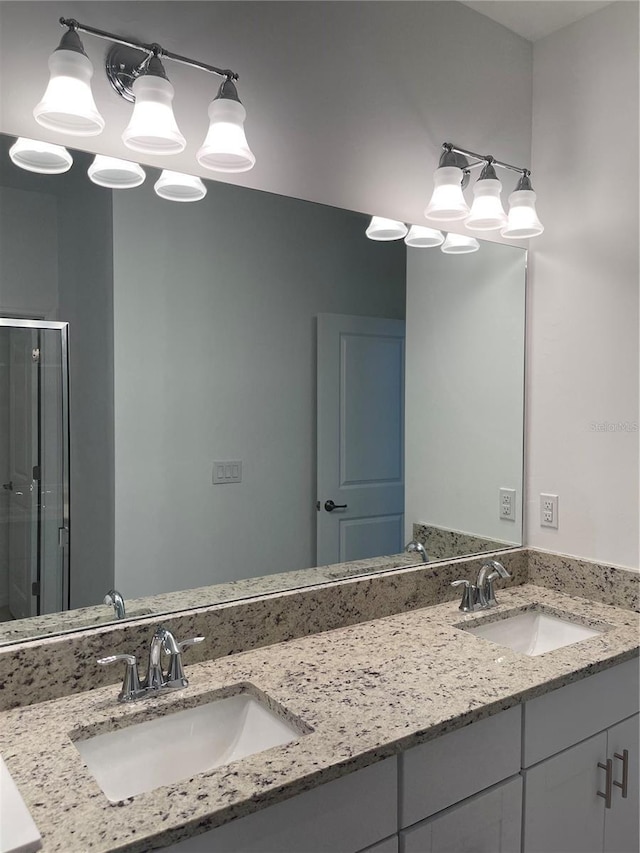 bathroom with vanity and a shower with shower door