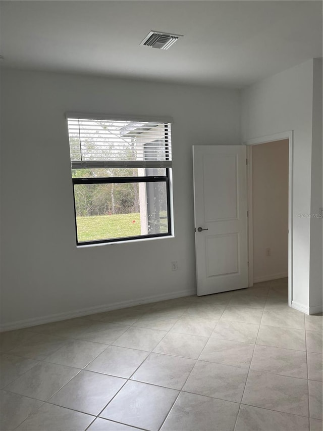 unfurnished room with light tile patterned floors