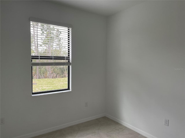 tiled empty room featuring a wealth of natural light