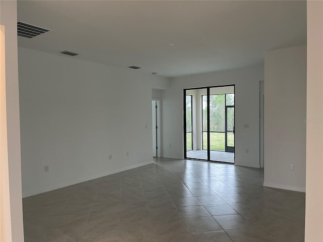 empty room with tile patterned flooring