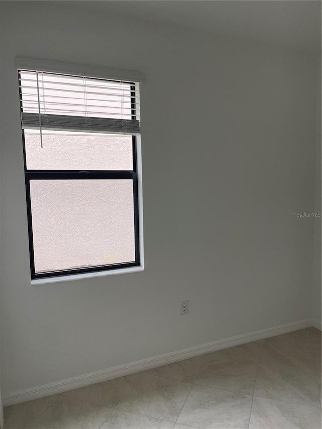 unfurnished room featuring tile patterned floors