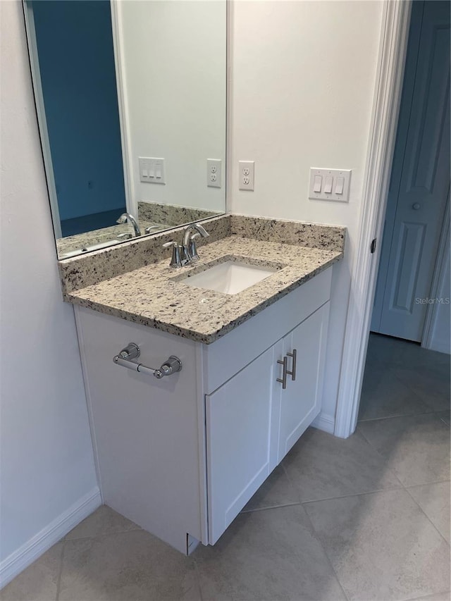 bathroom with tile patterned flooring and vanity