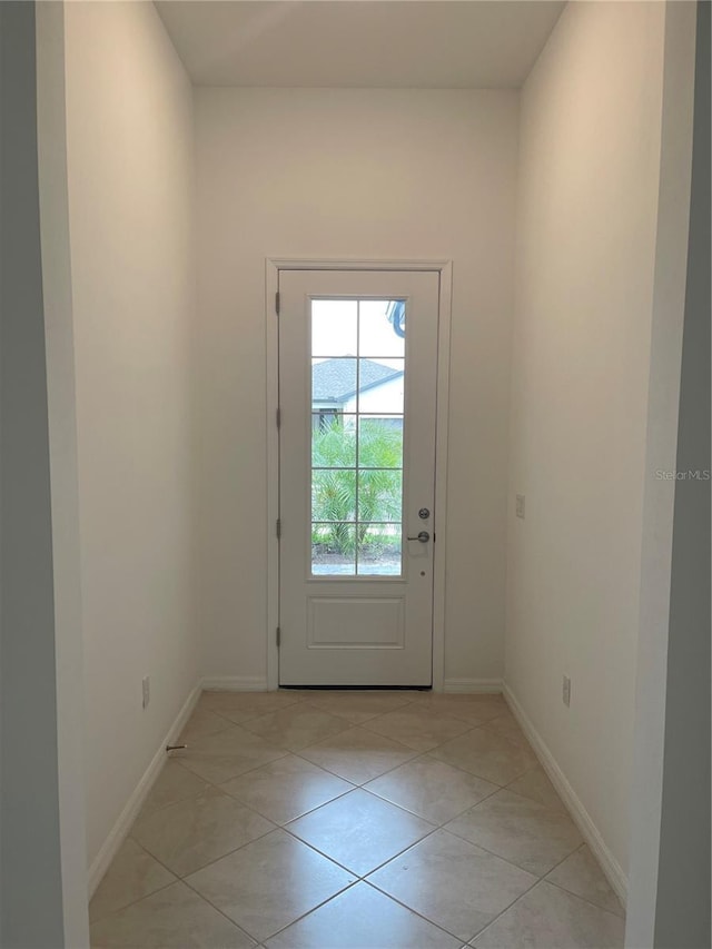 doorway featuring light tile patterned flooring