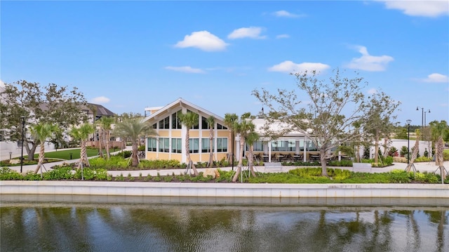 back of property featuring a water view